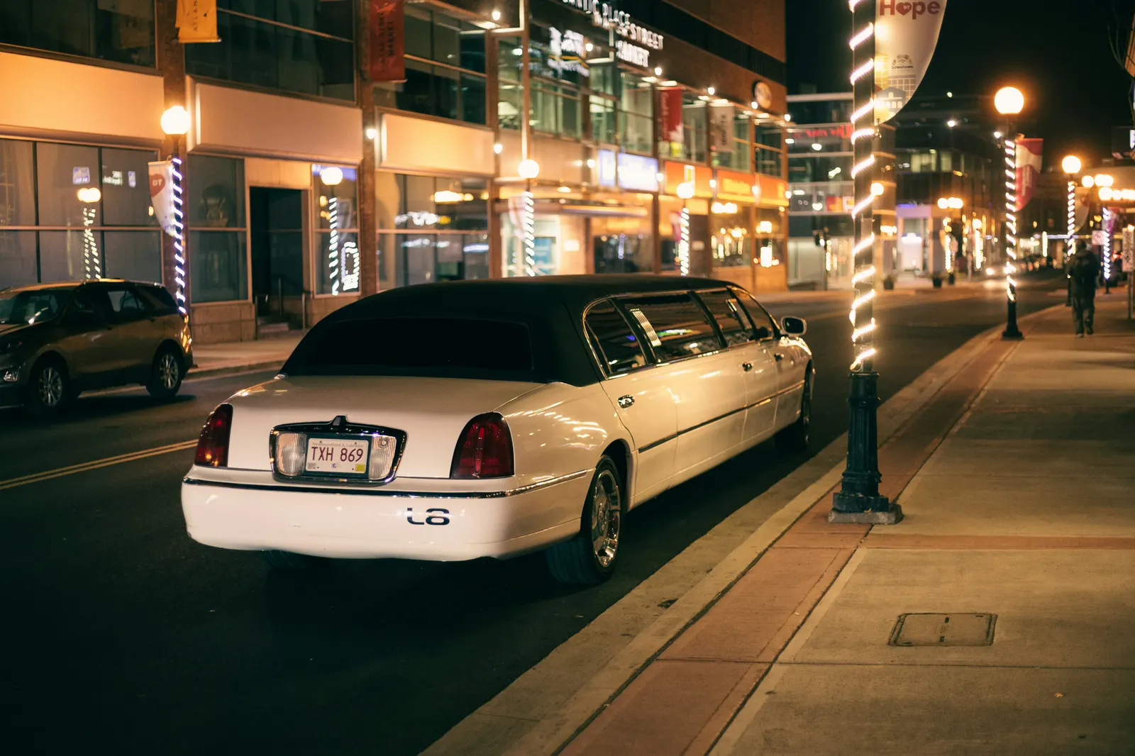 White stretch limousine on a downtown street at night